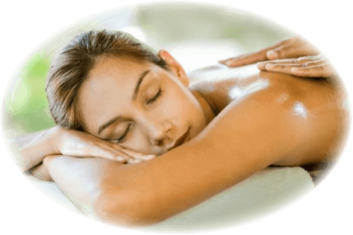 Woman laying facedown with hands massaging her.